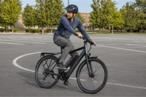 Helmeted adult rider practicing a controlled left turn on an e-bike in an empty parking lot.