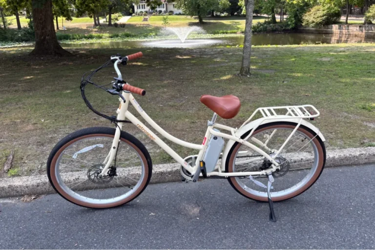 Retrospec Beaumont Rev 3 step-through electric city bike on a paved park road